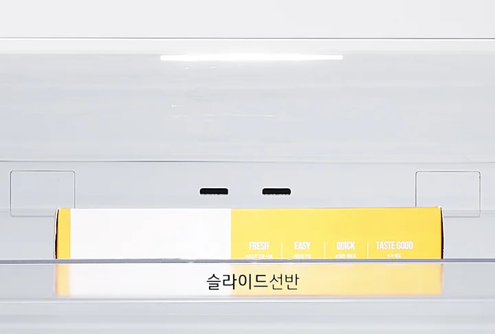 투명한 슬라이드 선반에 노란색과 흰색이 섞인 상자가 놓여 있습니다. 상자에는 FRESH, EASY, QUICK, TASTE GOOD라는 문구가 적혀 있습니다. 선반에는 슬라이드선반이라는 글자가 보입니다.